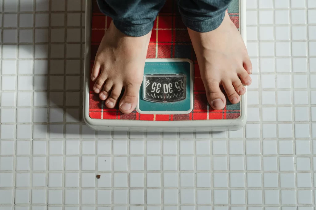 Bare feet standing on a scale.