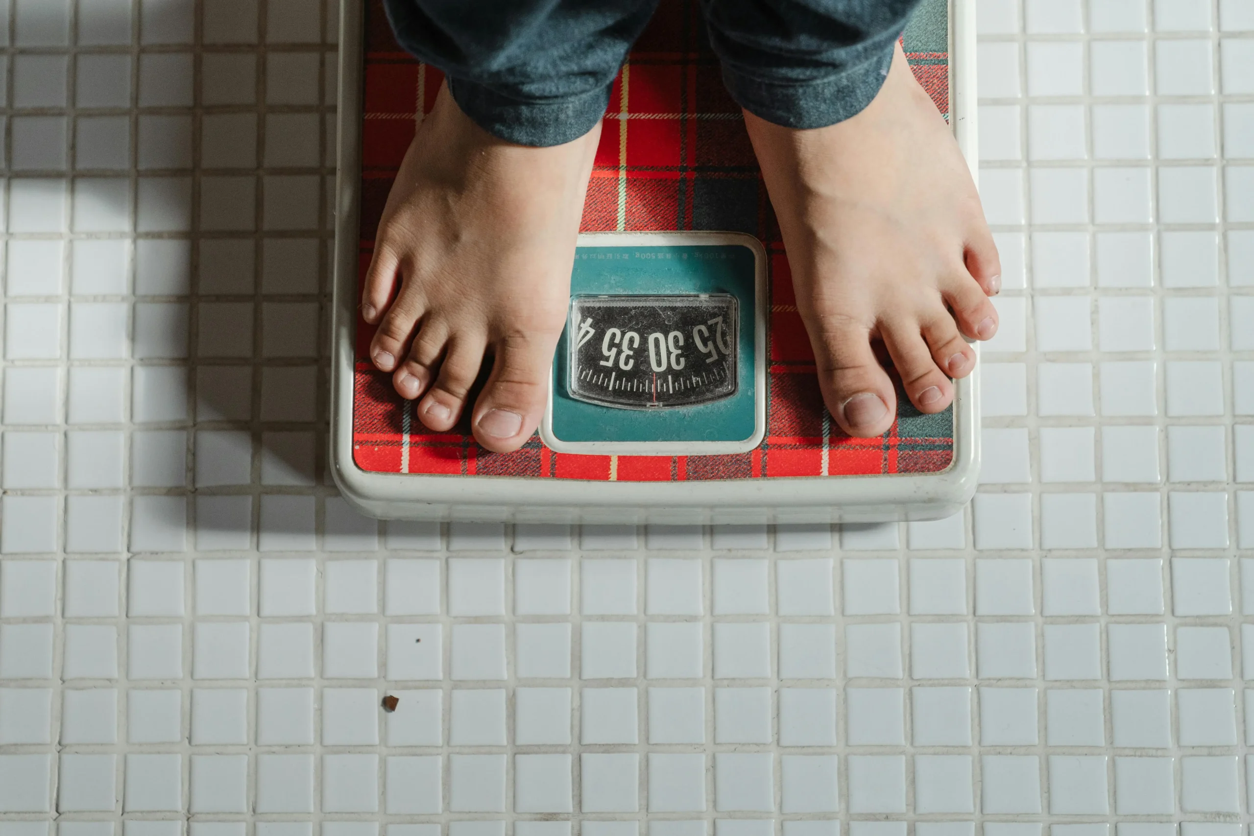 Bare feet standing on a scale.