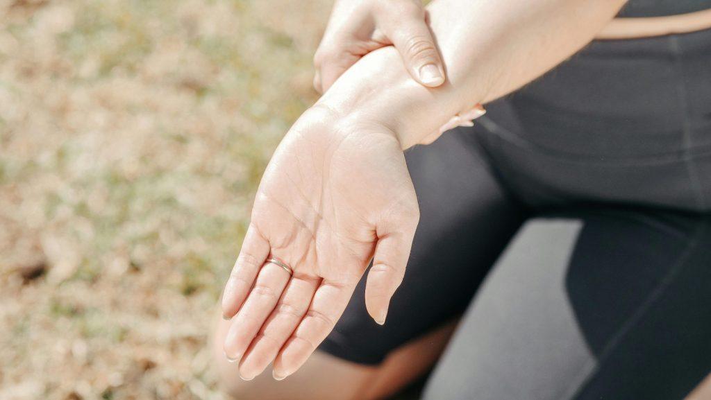 Person Holding Arm From Muscle Pain