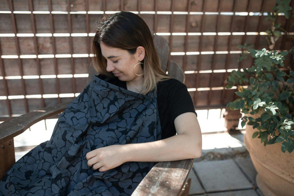 Woman breastfeeding with a cover