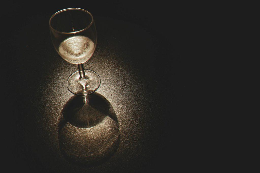 Glass of wine with light shining on it