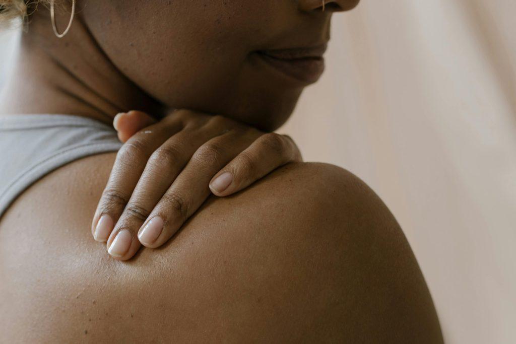Person holding their shoulder