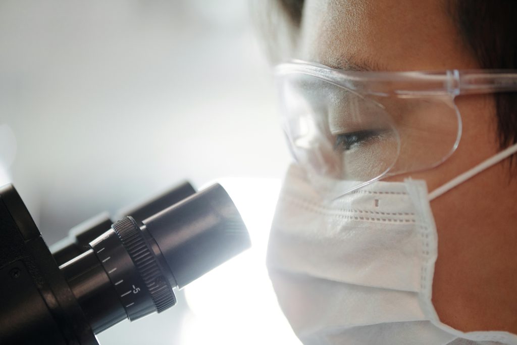 Doctor looking through a microscope