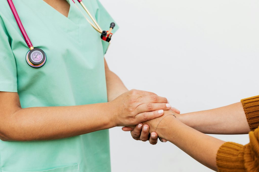 Doctor holding a patients hands