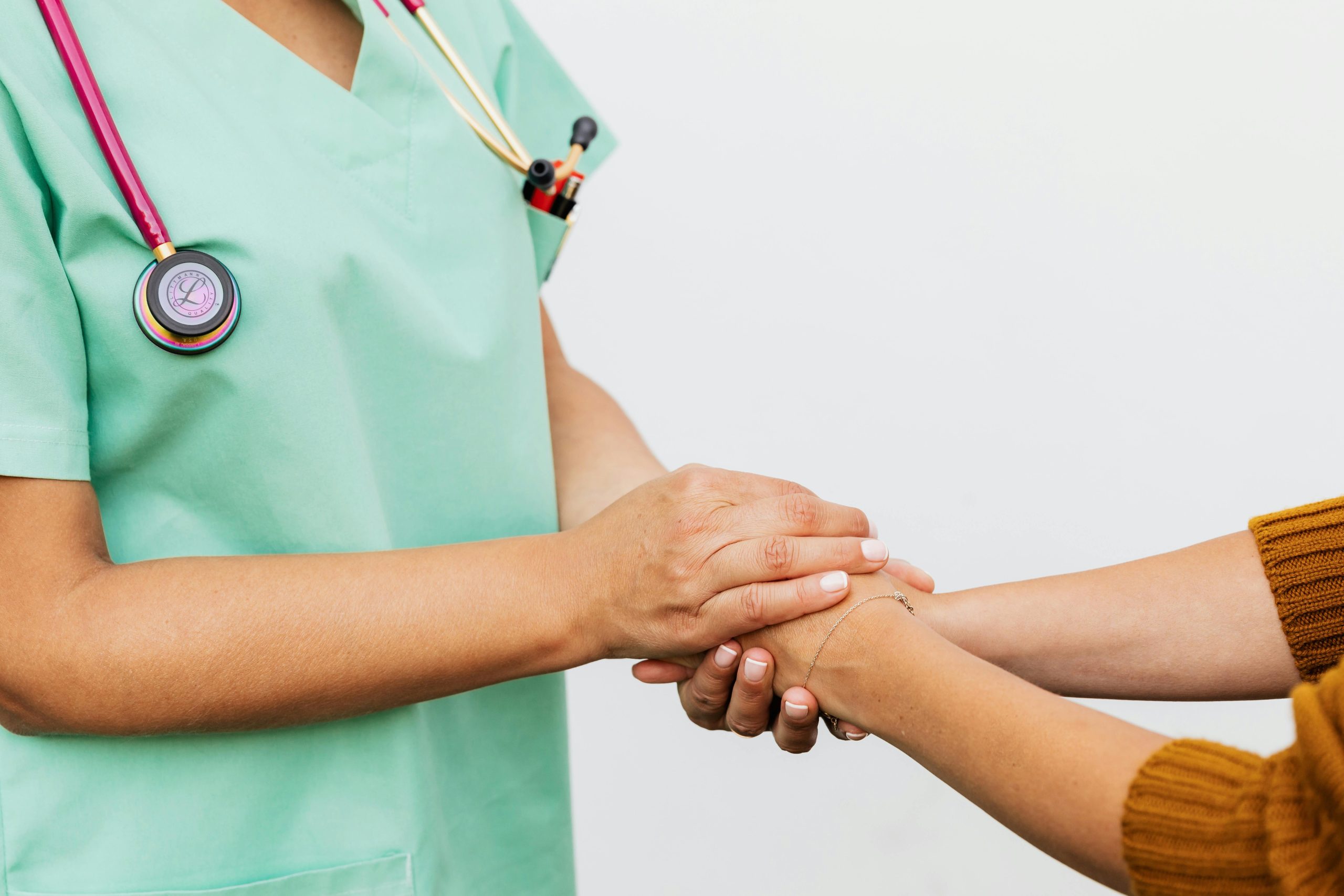 Doctor holding a patients hands