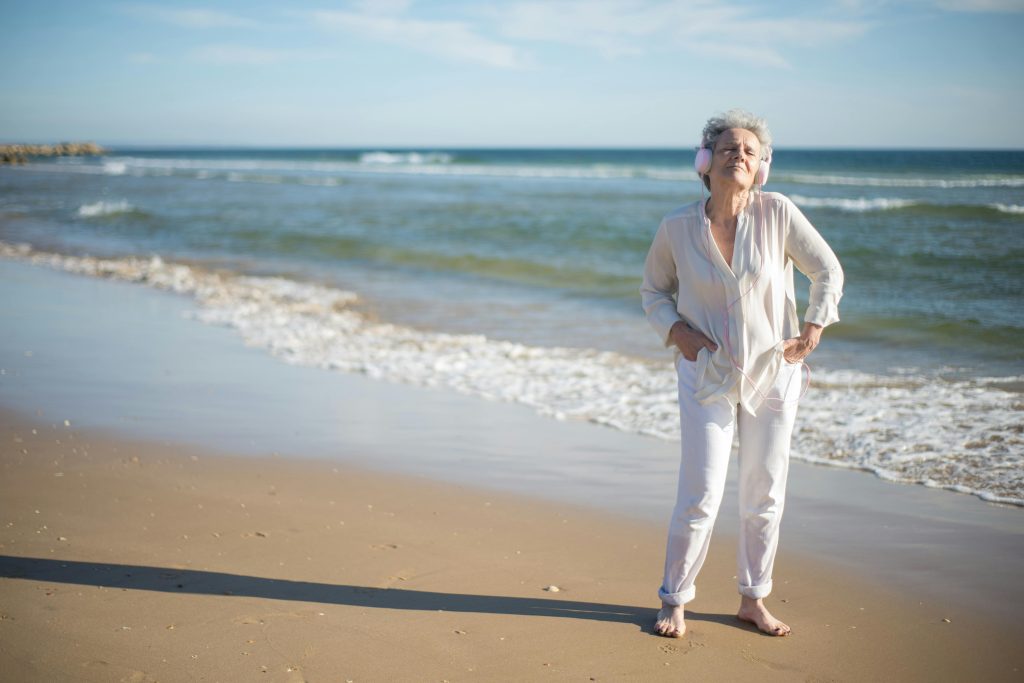 Older woman standing on a beach