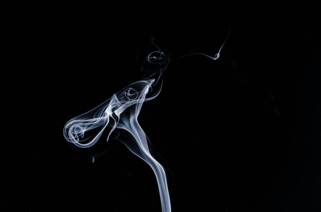 Smoke rising on a black background